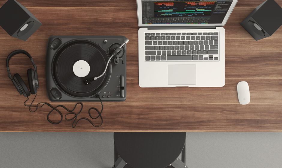 A home recording studio desk with monitors and an audio interface